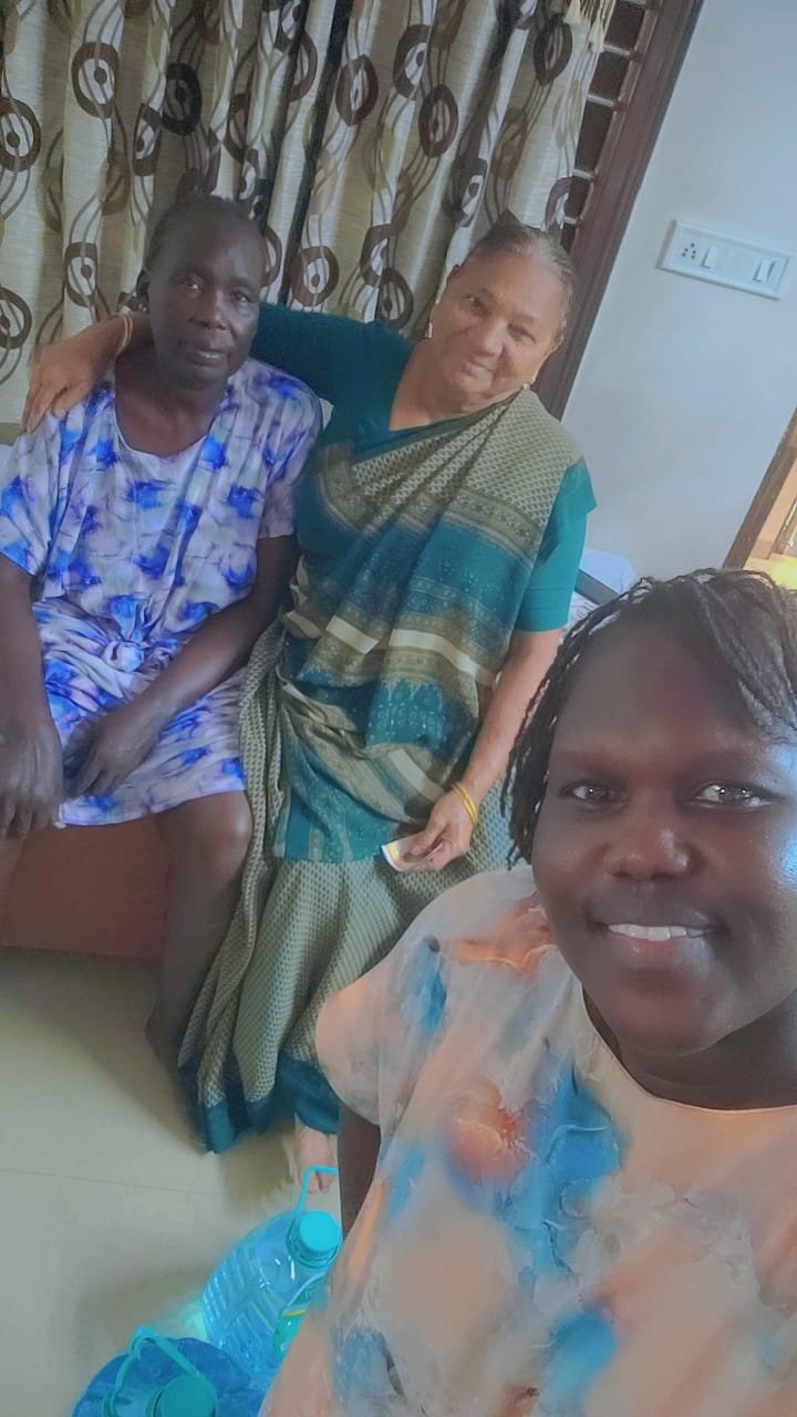 Photo of Champaben providing compassionate caregiving support to Kier Gideon Dau in a peaceful senior care center setting, symbolizing empathy, dedication, and humanity.