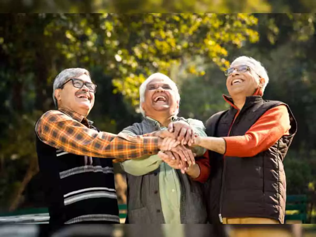 Elderly Indian couple sharing life experiences and smiling in a peaceful senior care home environment.